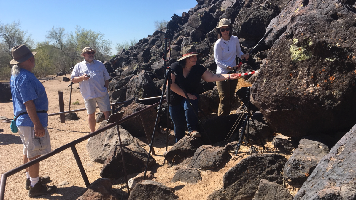 photo of archaeology team photographing petroglyphs
