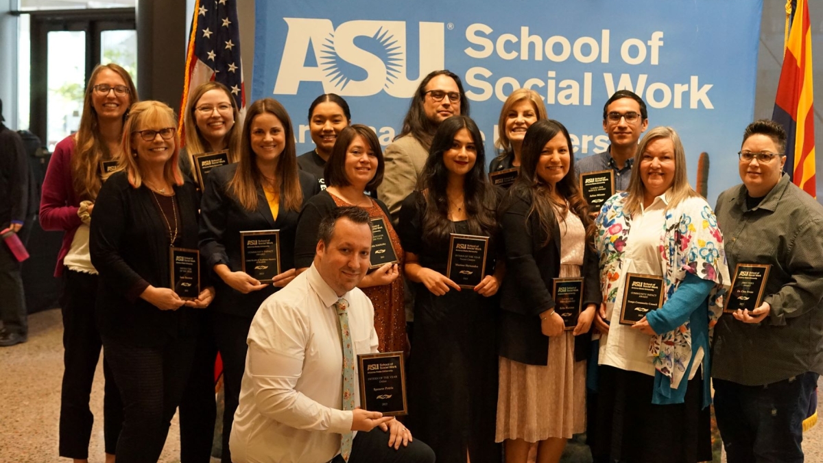 Winners of 2023 ASU Social Work Month Awards post for a photo with their awards.