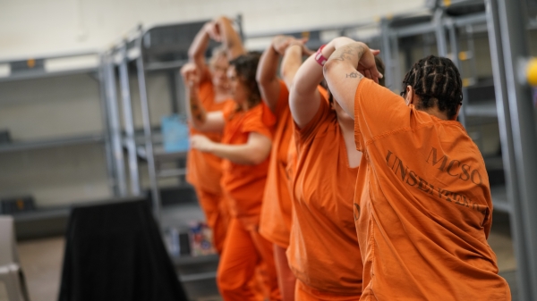 Incarcerated women come together during the final performance in front of jail staff and ASU Gammage donors.