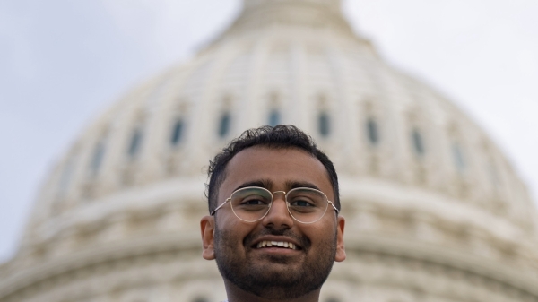 ASU student Jameel Subhan wearing a suit and tie and smiling while standing in front of the U.S. Capitol building in Washington, D.C.