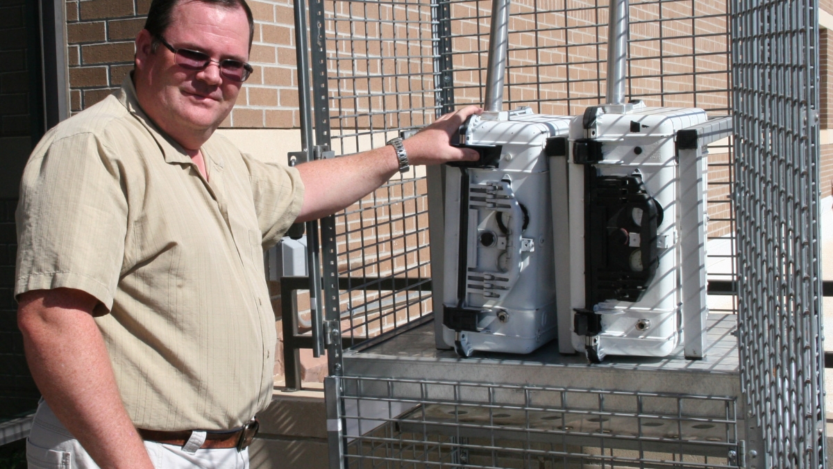 man pictured with air-quality monitoring equipment on ASU West campus