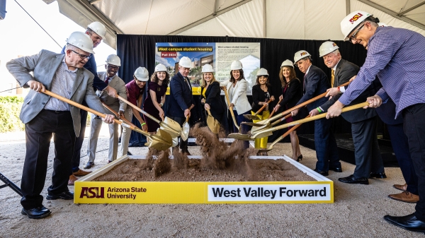 Group of people shovel dirt during groundbreaking ceremony at ASU's West campus