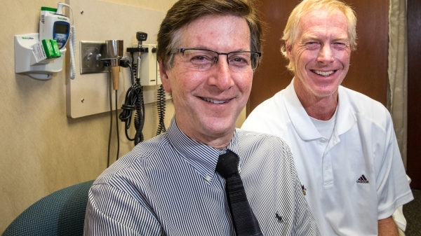 two men in a doctor's office smiling