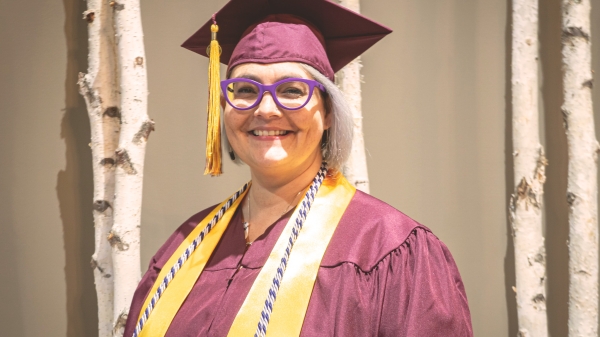 Kristine Anderson pictured wearing her ASU graduation gown and stole.