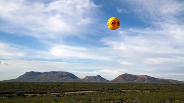 A photograph of a balloon over the southern border
